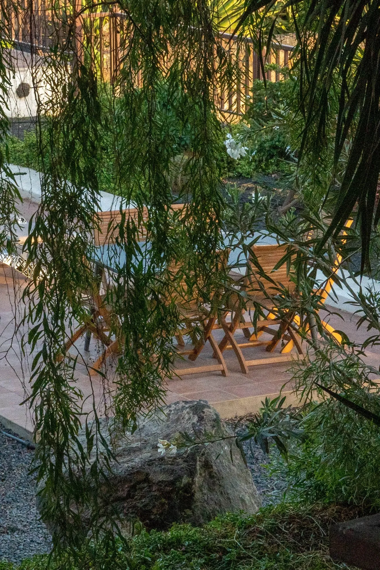An outdoor table under the trees in the garden