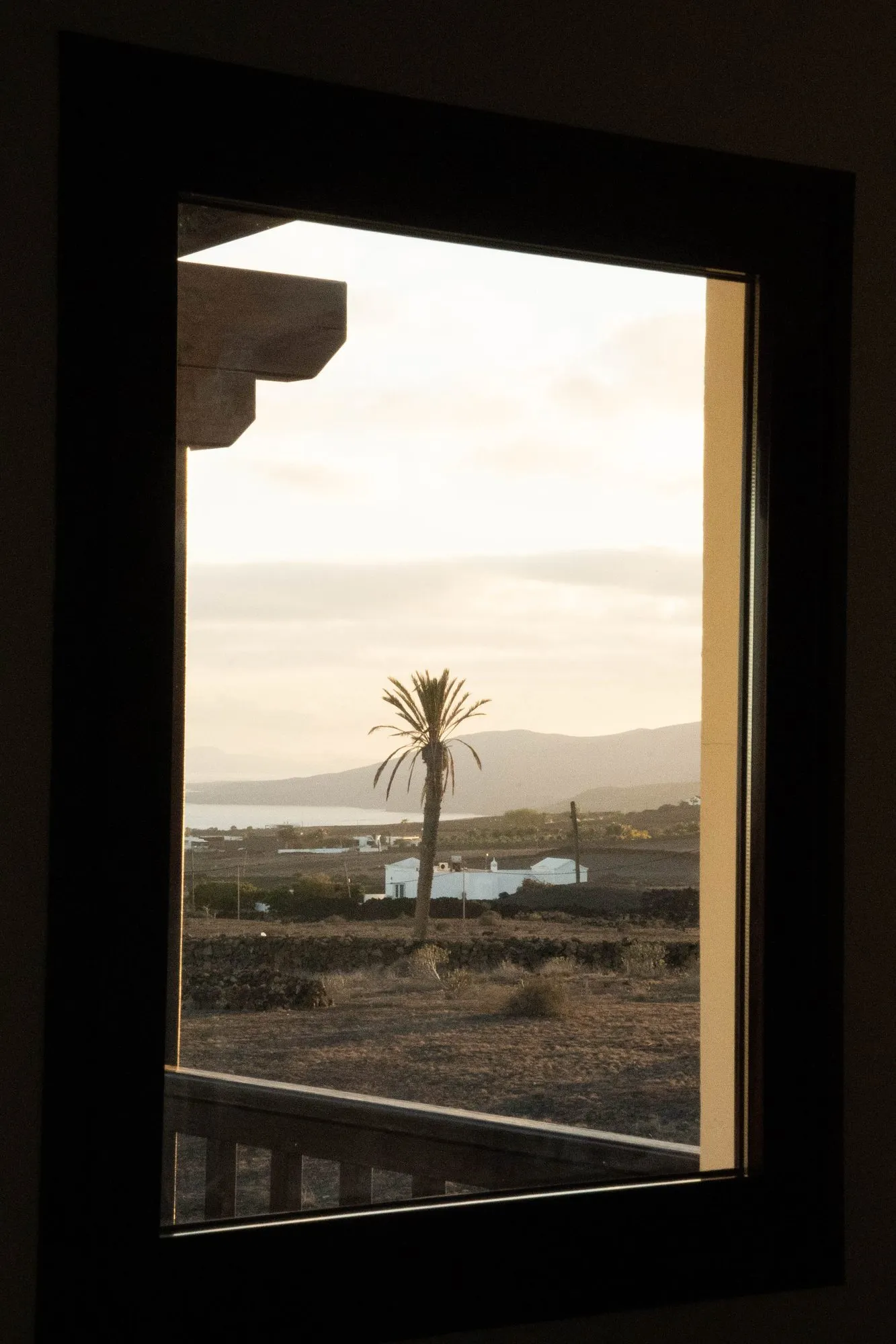 The view from a window, over the plain to the sea